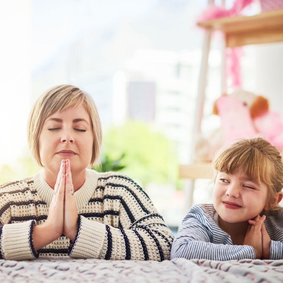 Child peaking at Mom praying for Striving for Sainthood